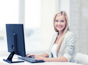 picture of smiling businesswoman using her computer